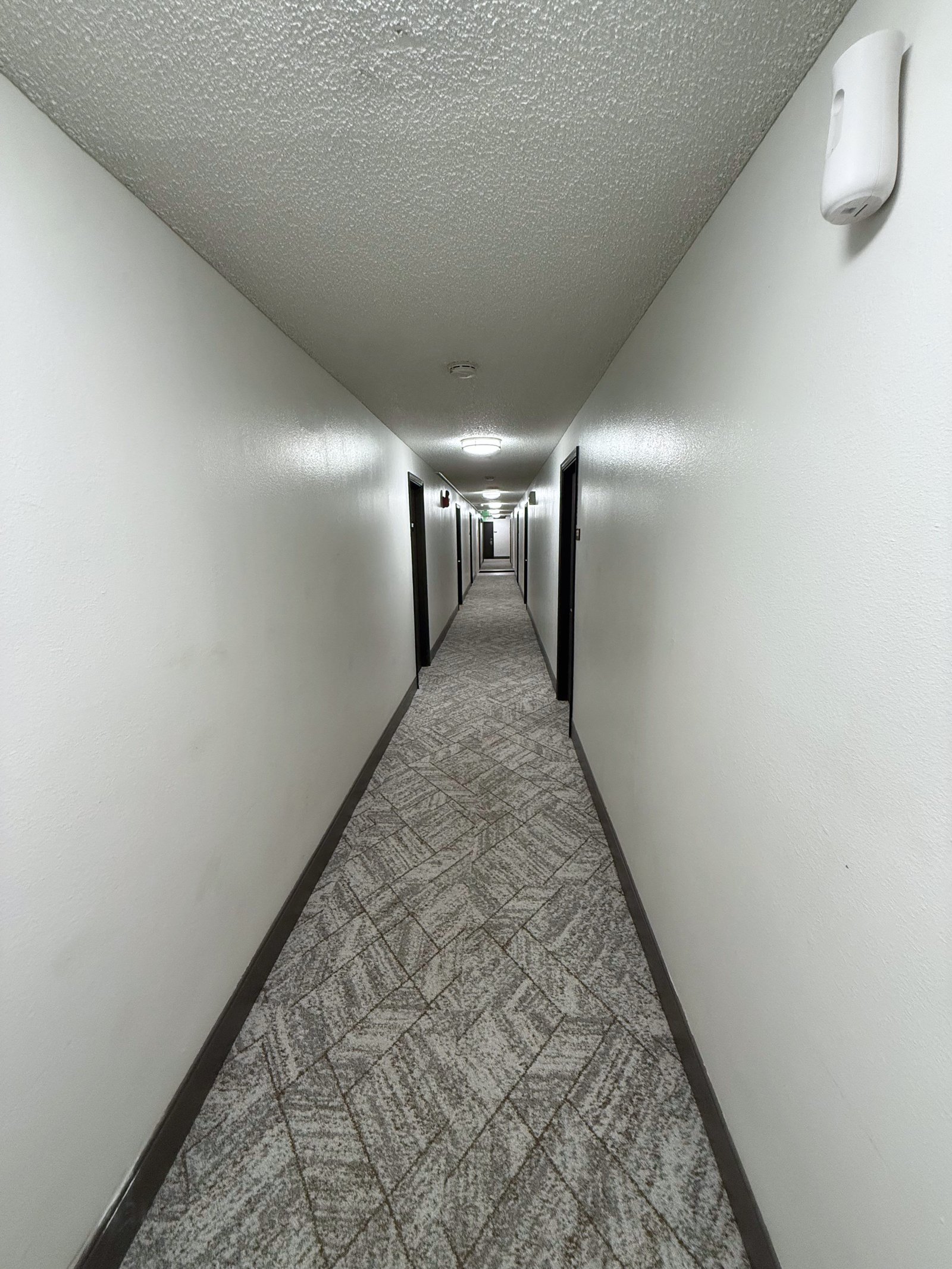 Hermiston Inn & Suites guest hallway leading to rooms