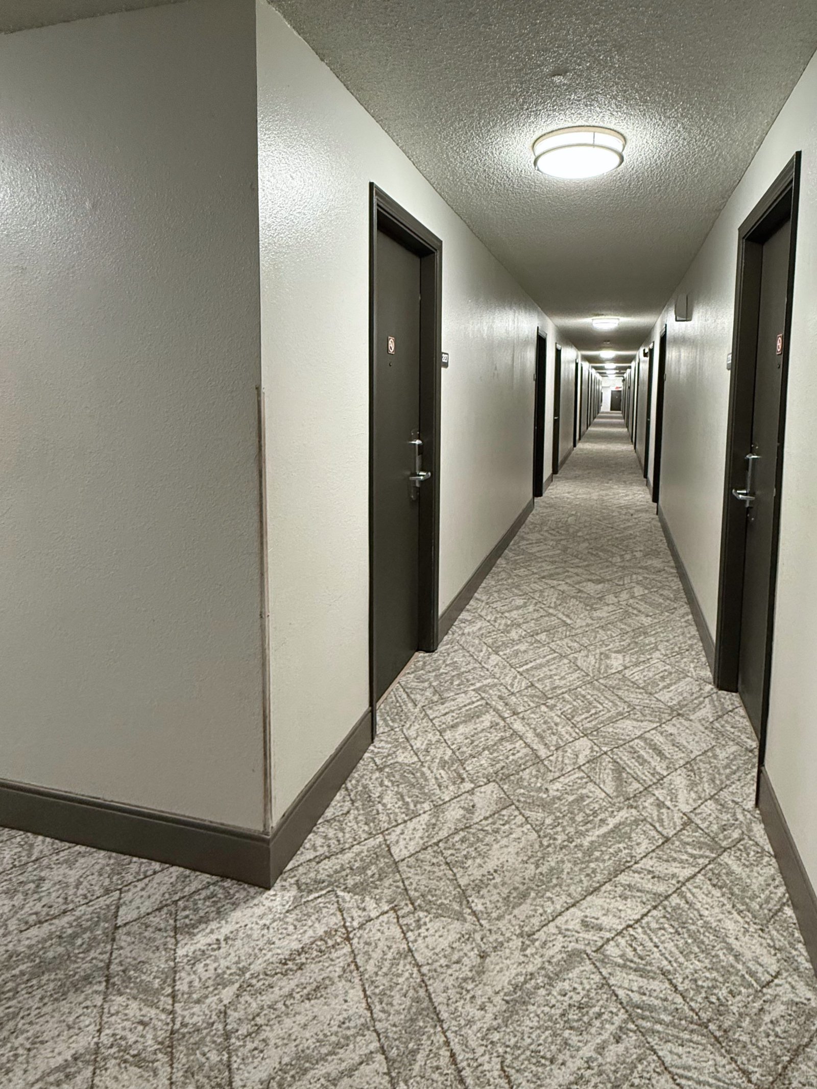 Hermiston Inn & Suites interior corridor with room doors